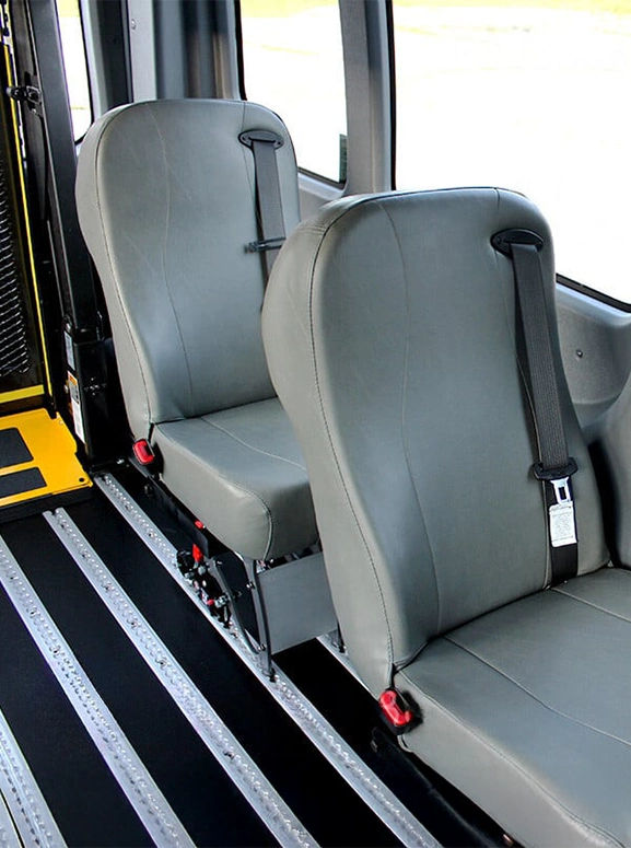 gray bus seats with seat belts